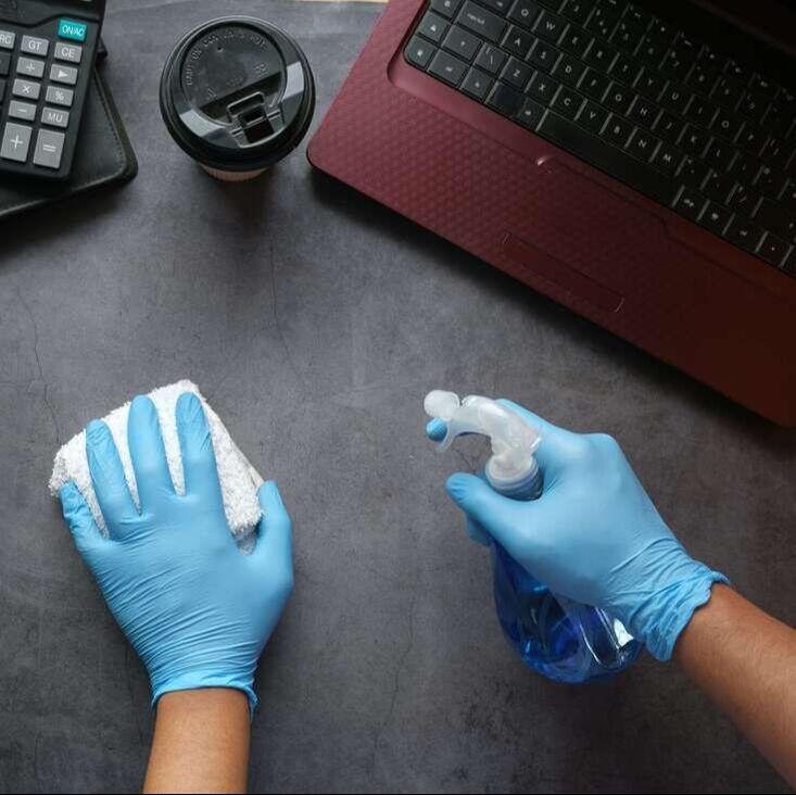 Cleaning office hands in gloves